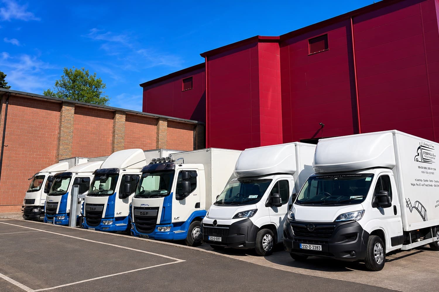 The Esteeville box truck fleet lined up at a studio yard